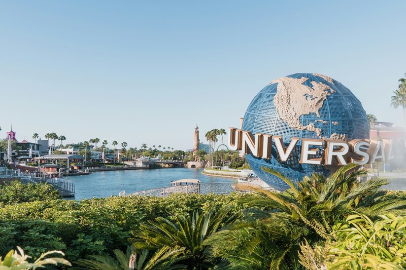 Globo Universal Studios em Orlando, com palmeiras e céu claro